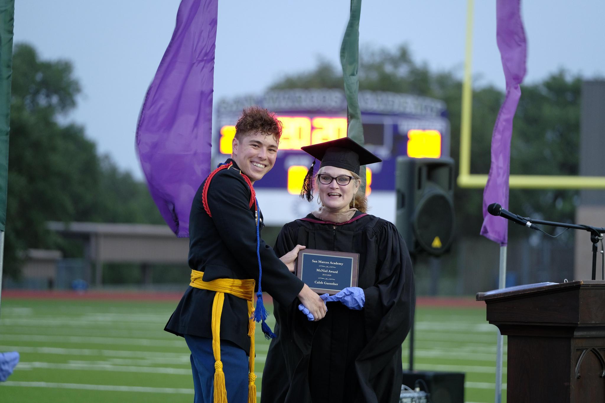 Caleb Guenther of San Marcos accepts the McNiel Cup Award from Academy CFO Rhonda McNeil. The McNiel Cup is the second highest student award given at the Academy. Guenther will be attending Mary Hardin-Baylor in the fall to pursue a degree in music business.
