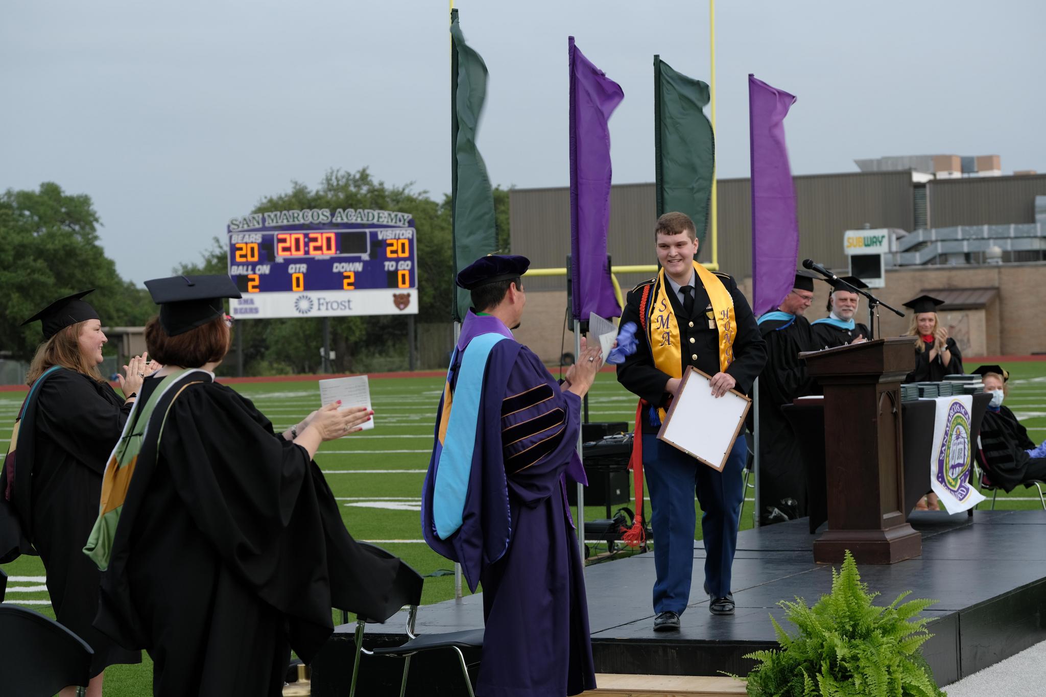 After delivering the Valedictorian Address, Carter Pruitt of New Braunfels, Texas, exits the stage to a standing ovation. Pruitt will enter the University of Texas at Austin this fall to pursue a degree in architectural engineering.