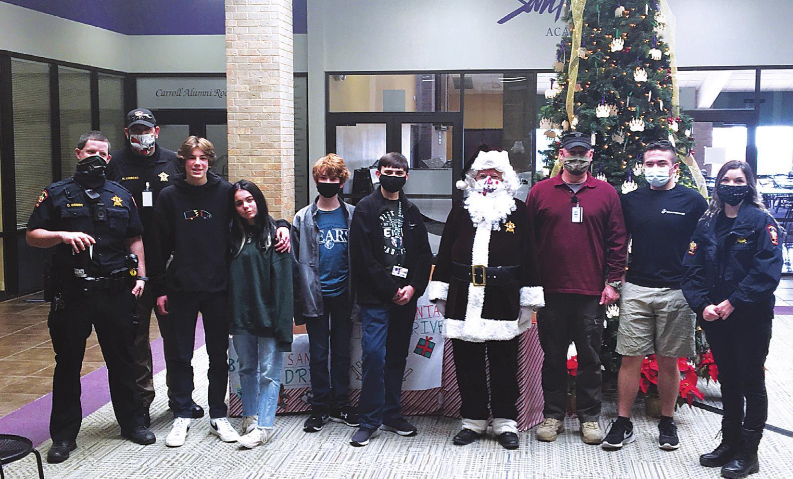 San Marcos Academy's Corps of Cadets presents toys for Brown Santa