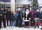 San Marcos Academy's Corps of Cadets presents toys for Brown Santa